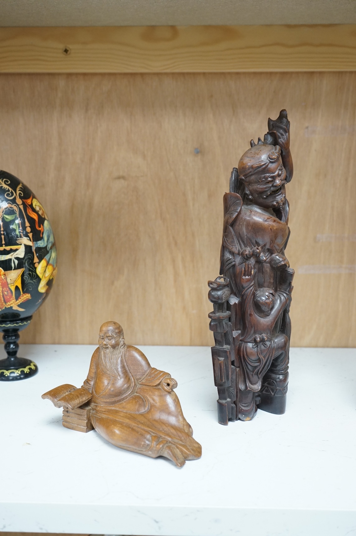 A Chinese root carving of a luohan and another of a reclining monk, largest 26cm high (2)